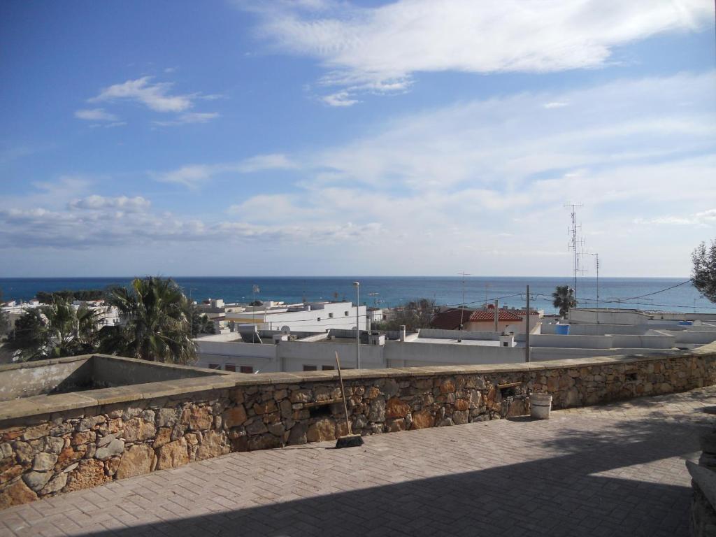 a stone wall with the ocean in the background at B&B Lu Cantoru in Marina di Pescoluse