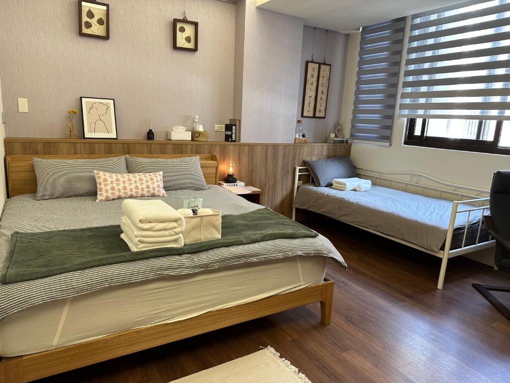 um quarto com uma cama e uma pequena cama e uma cadeira em 三木三白包棟民宿 em Puli