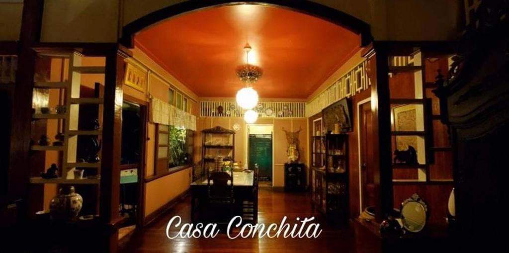 a hallway with an archway in a room with shelves at CASA CONCHITA BED & BREAKFAST in Taal