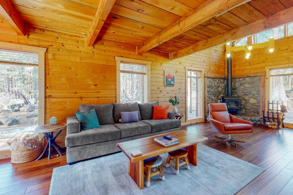 a living room with a couch and a table at Cascade Cabin in Sunriver
