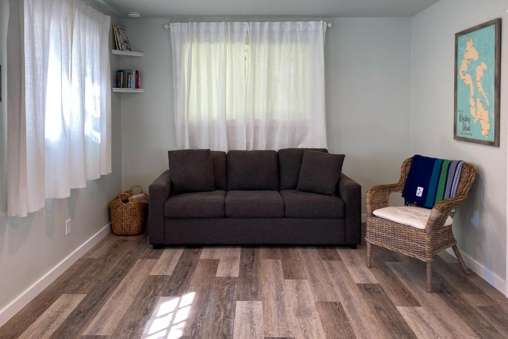 ein Wohnzimmer mit einem Sofa und einem Stuhl in der Unterkunft Haven's Way Cottage in Clinton