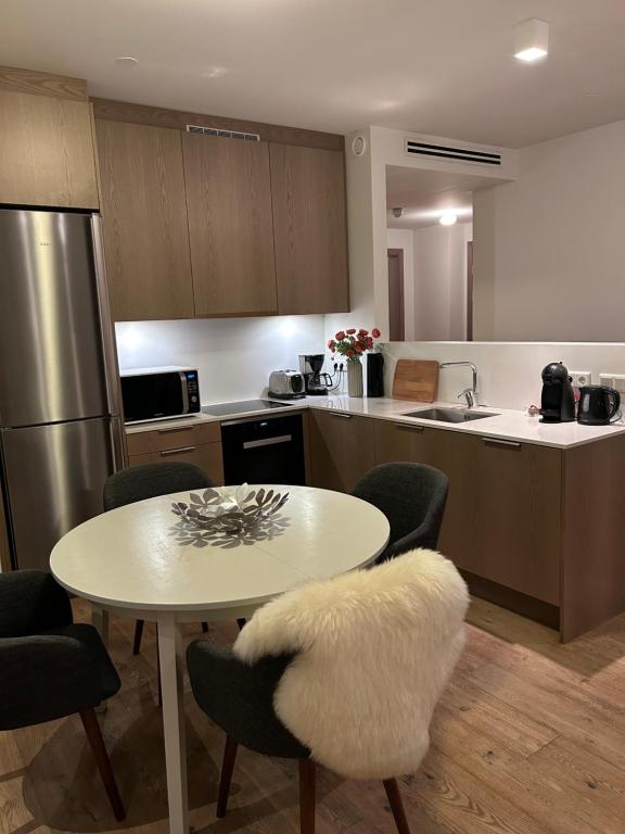 a kitchen with a white table and chairs and a counter at Reykjavikrental in Reykjavík