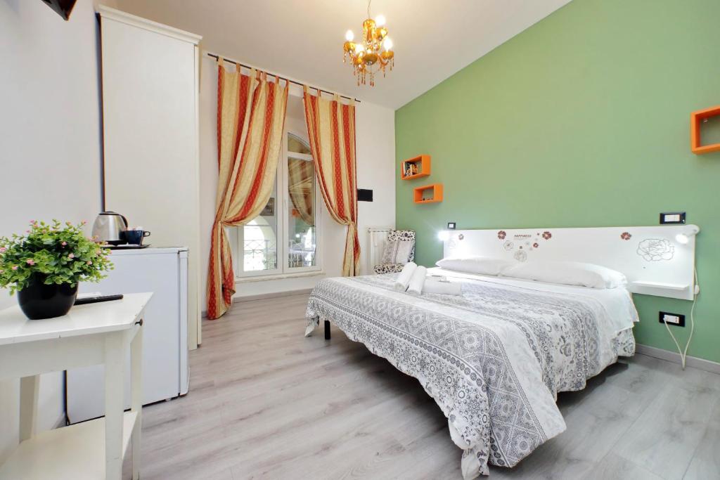 a bedroom with a white bed and a window at Lucky Holiday Rooms in Rome