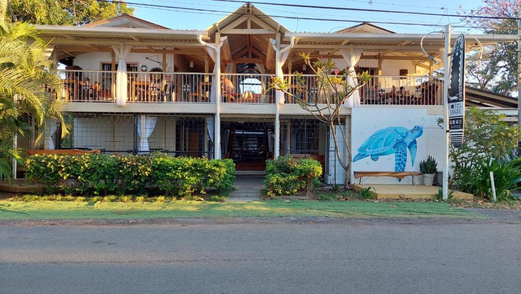 a house with a dolphin painted on the side of it at Hotel M&M Beach House in Coco