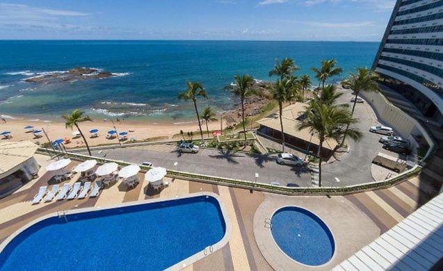 a view of a beach and the ocean from a hotel at Belo apartamento Ondina Apart in Salvador