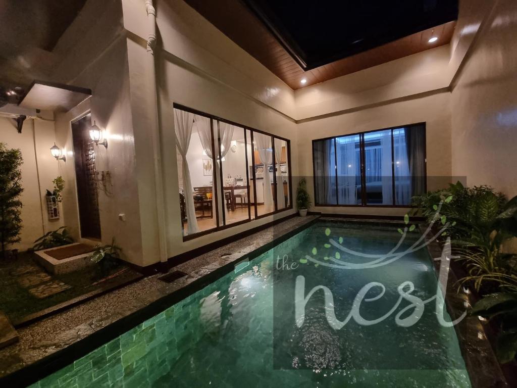 a swimming pool in the middle of a house at The Nest at Luana in Porac