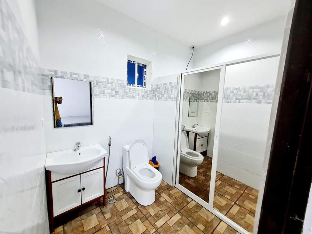 a white bathroom with a toilet and a sink at WYNDAM POOL VILLA in Angeles
