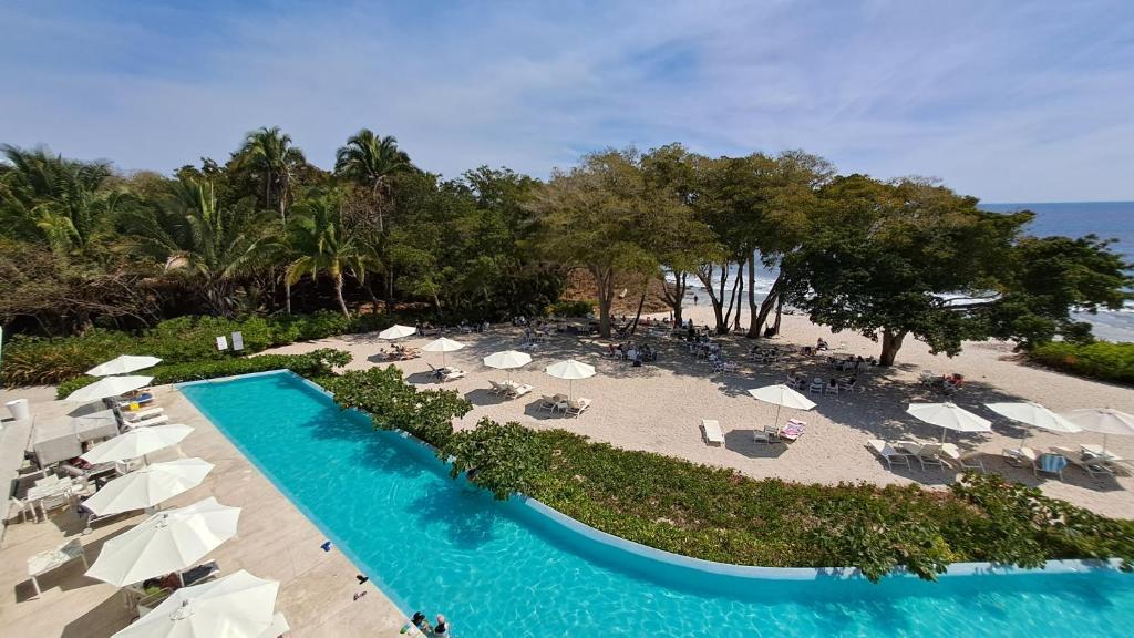 an aerial view of a resort with a pool and beach at Luxury 2 bedrooms Bolongo Punta Mita in Higuera Blanca