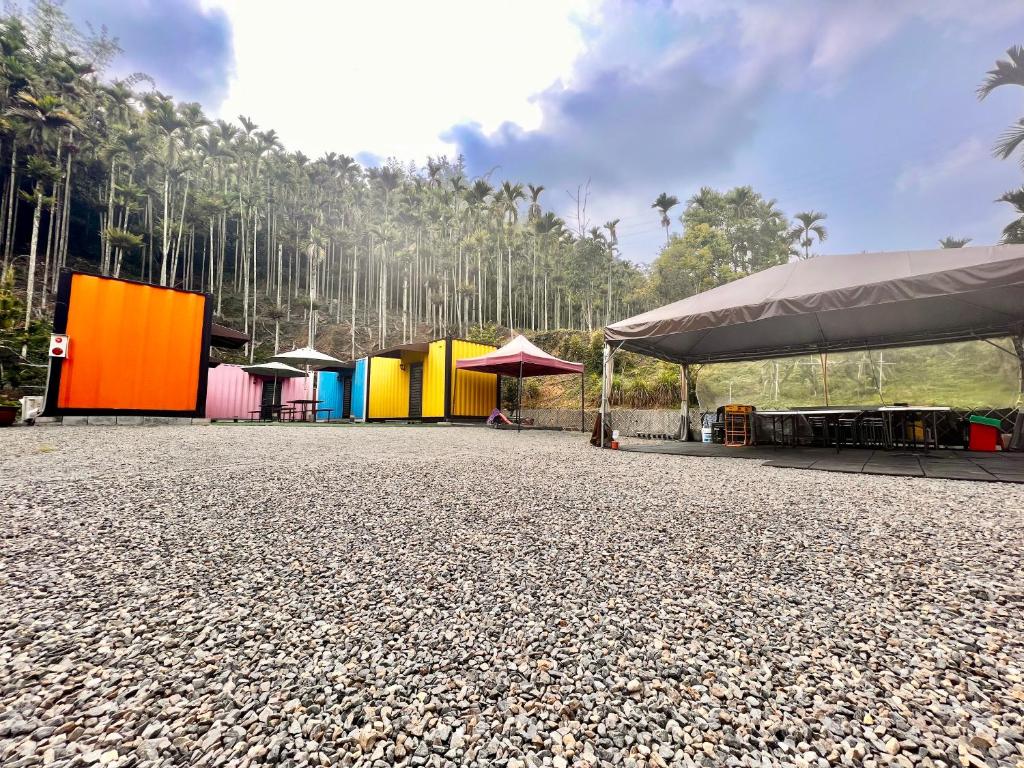 a group of colorful buildings with trees in the background at Tea King B&B in Yuchi