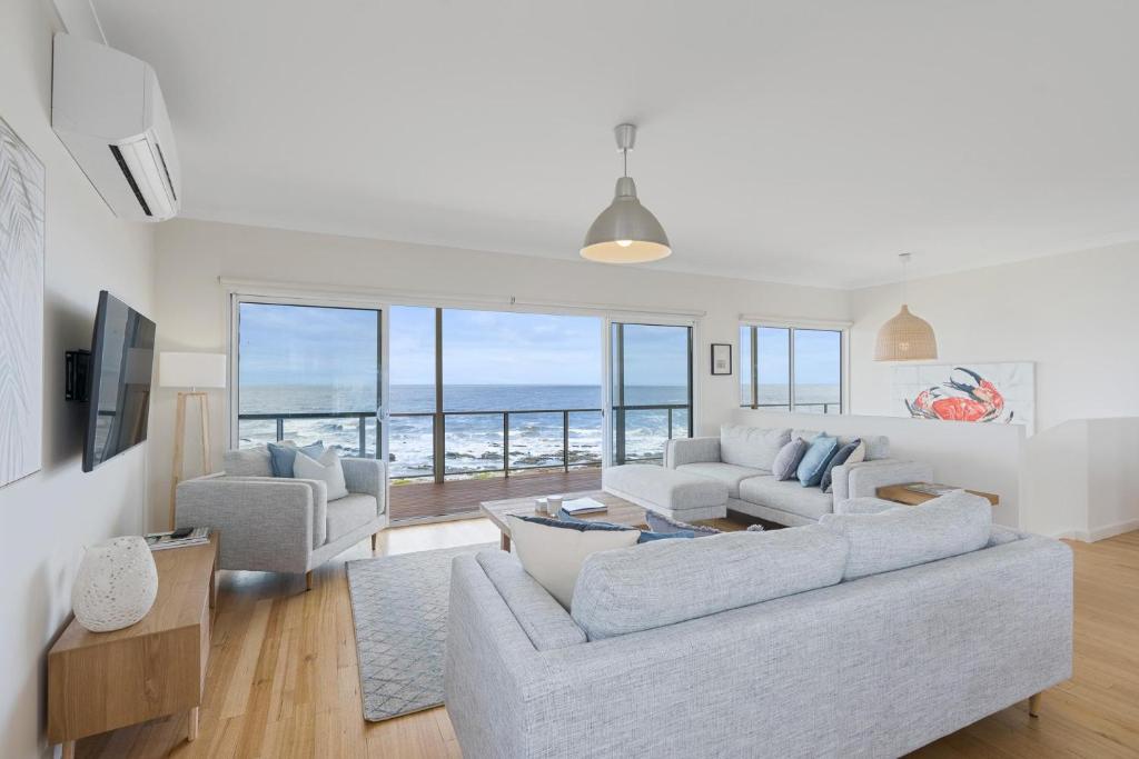 a living room with a view of the ocean at Ray's Beach House at 58 Ocean Parade Middleton in Middleton