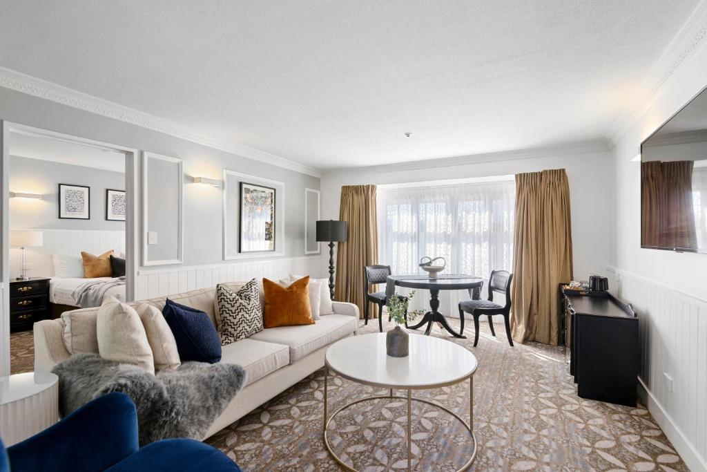 a living room with a couch and a table at Scenic Hotel Cotswold in Christchurch