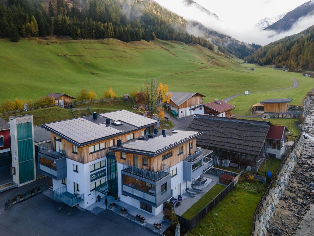 an aerial view of a house in the mountains at Aparthotel Ambiente in Umhausen