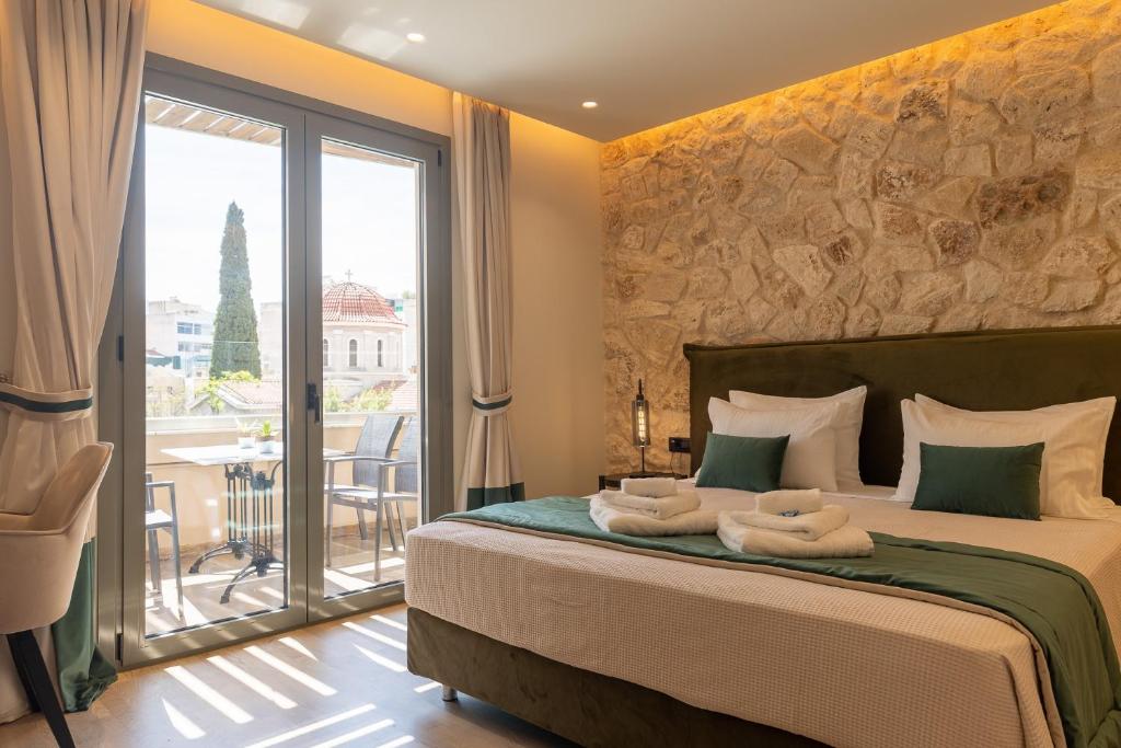 a bedroom with a large bed with towels on it at Philia Boutique Hotel in Athens