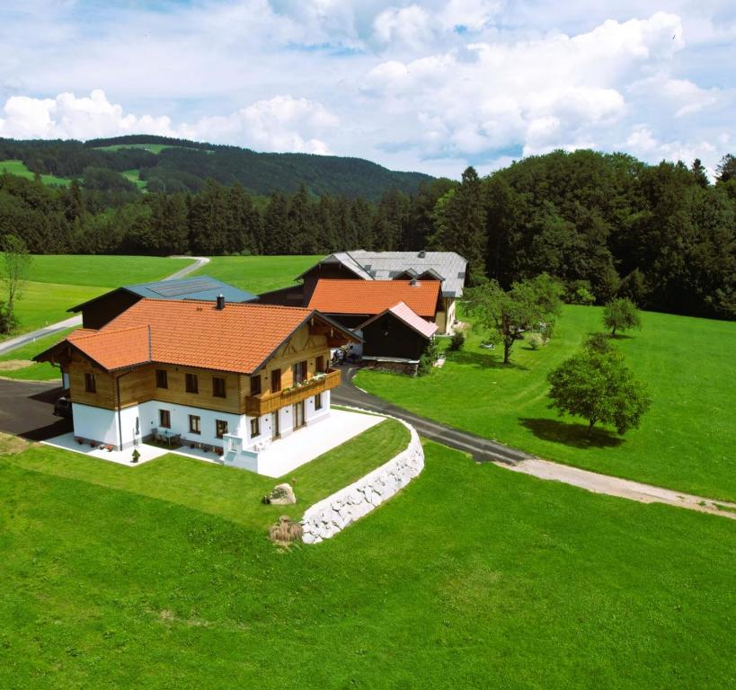 an aerial view of a house on a green field at Landhaus Stadlmann in Thalgau