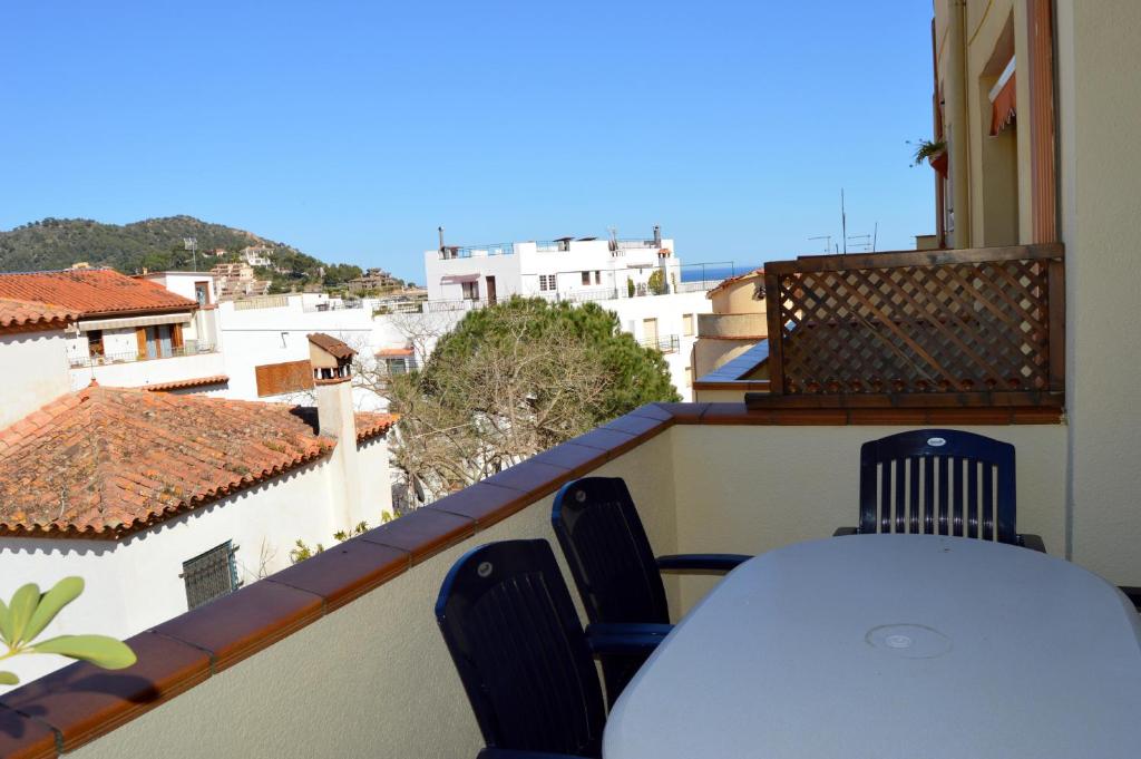 a table and chairs on a balcony with a view at Casa con piscina en el Casco Historico in Tossa de Mar