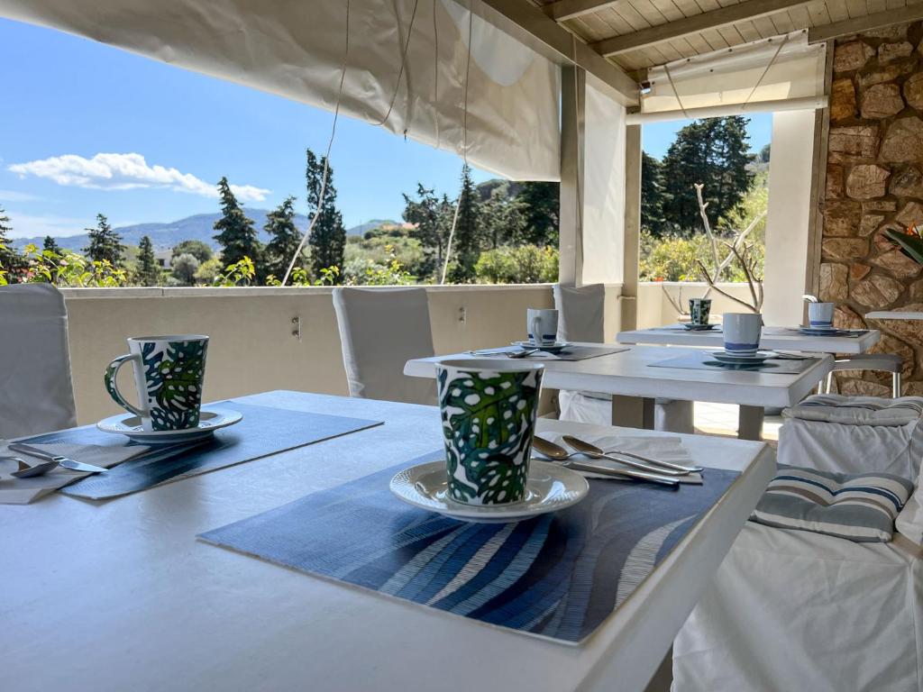 a table and chairs on a patio with a view at A casa di Enrico B&B in Portoferraio