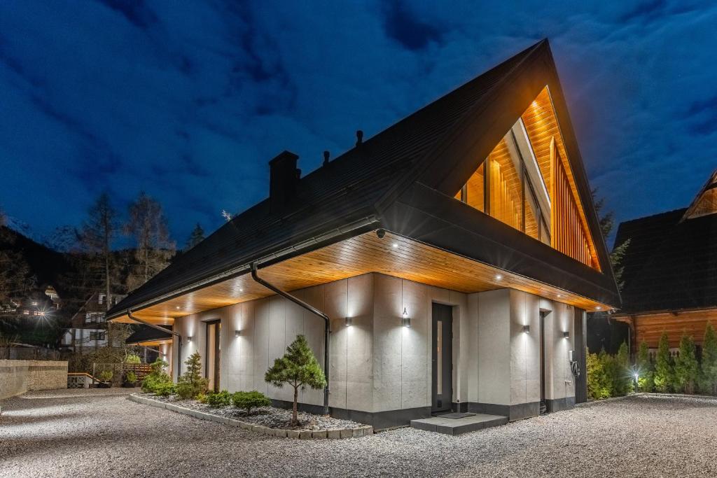 a house with a black roof at Góralska Domina Ville Premium in Zakopane