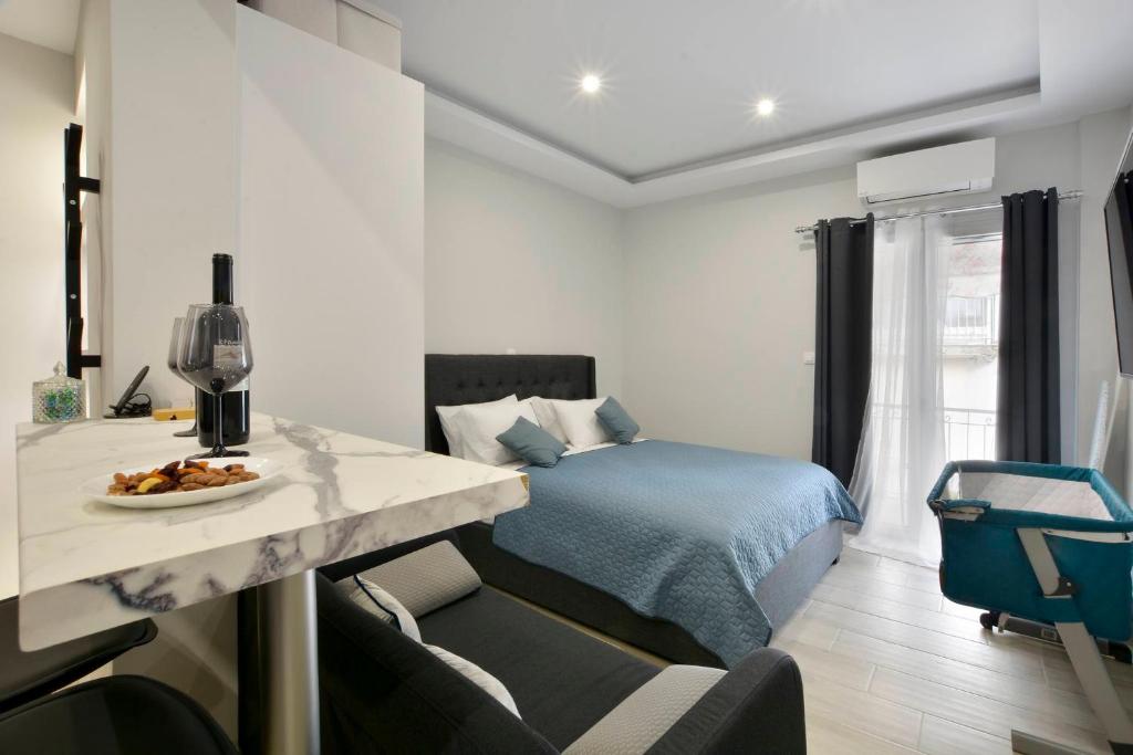 a bedroom with a bed and a table with a bowl of food at Saroko Studio in Corfu