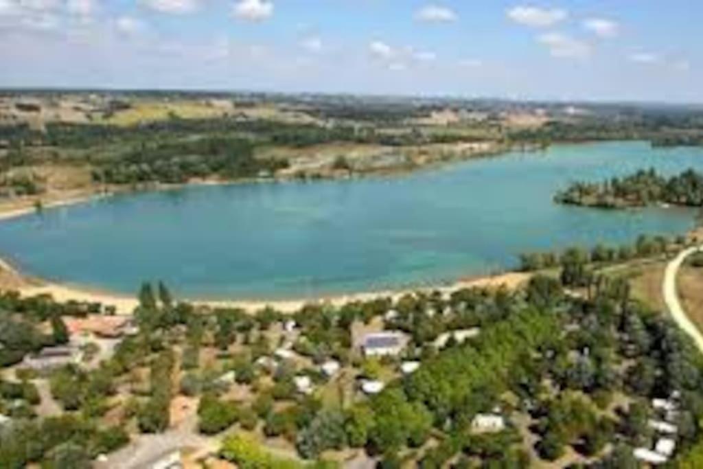 an aerial view of a lake with houses and trees at La Valette, XVIIs House, Futuroscope in Saint-Léger