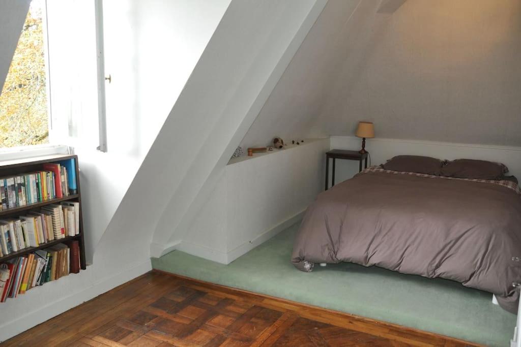 a bedroom with a bed and a book shelf at La Valette, XVIIs House, Futuroscope in Saint-Léger