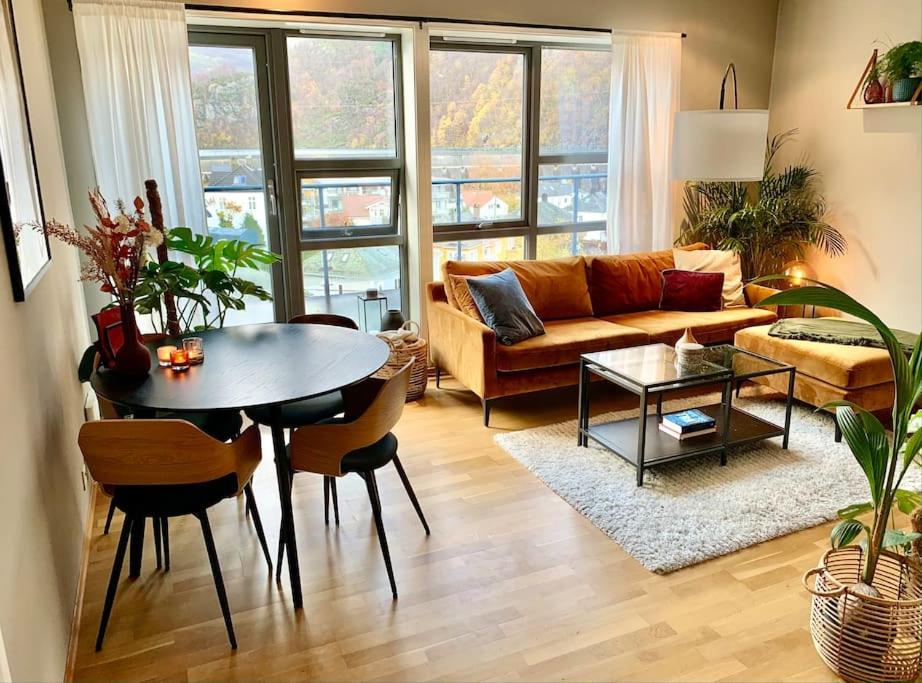 a living room with a couch and a table at Top floor apartment with mountain view, terrace 22sqm, free parking in Bergen
