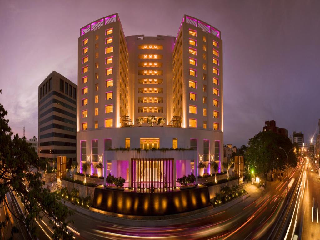 a large building with purple lights on top of it at The Raintree, Anna Salai in Chennai