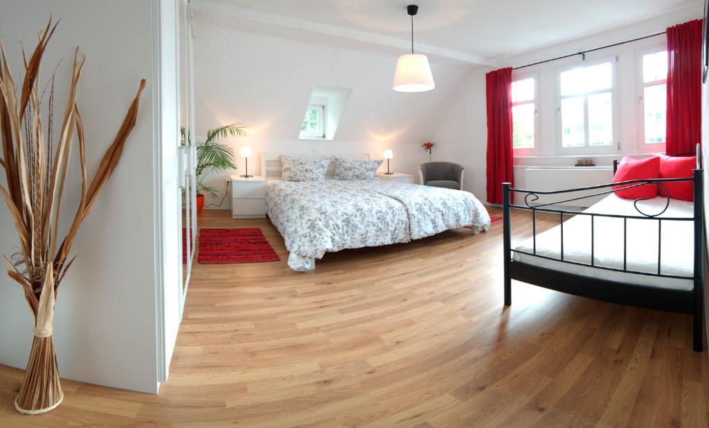 a bedroom with a bed and a wooden floor at Appartement Stadtpartie in Suhl