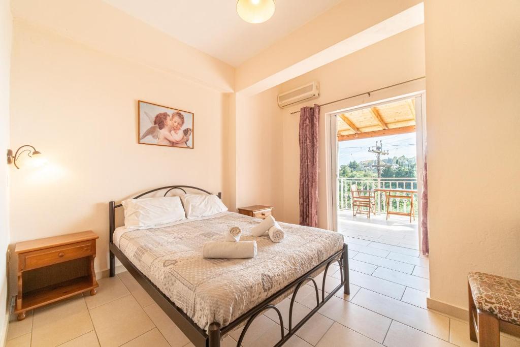 a bedroom with a bed and a balcony at Arianna Studio 9 in Paleokastritsa