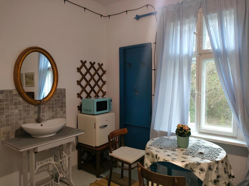 a bathroom with a table and a sink and a microwave at Willa Gaszek in Inowłódz