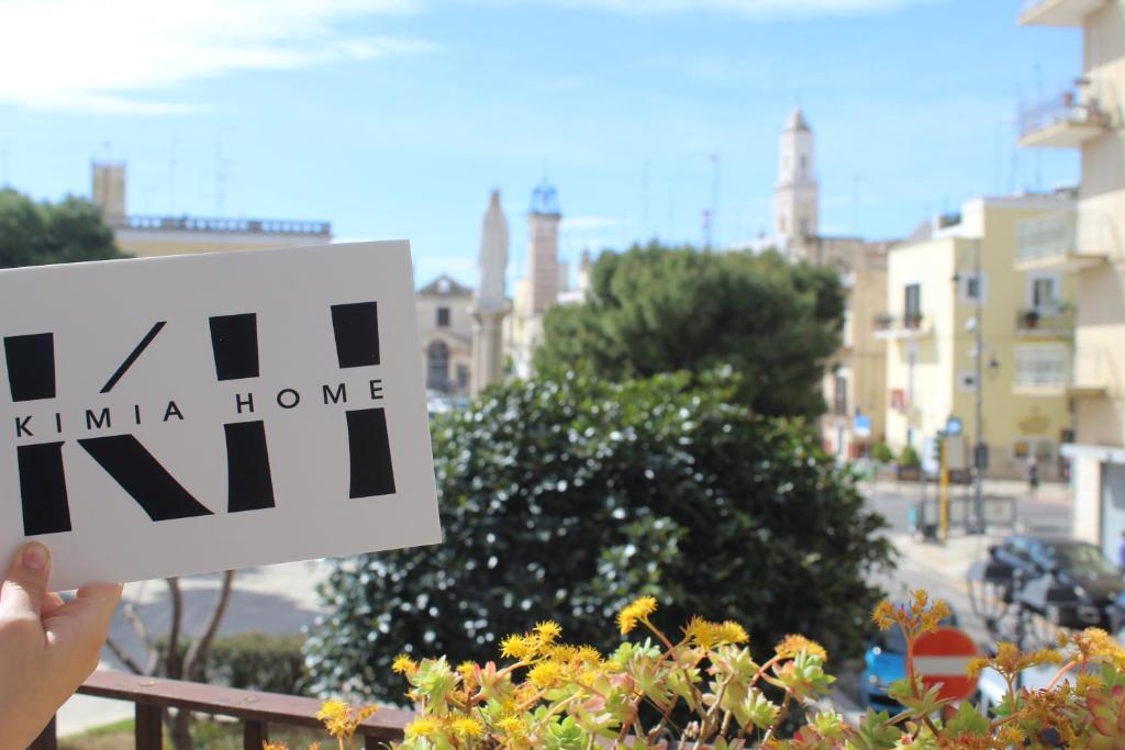 a person holding a sign that reads kima home at KiMia Home, centro in Modugno