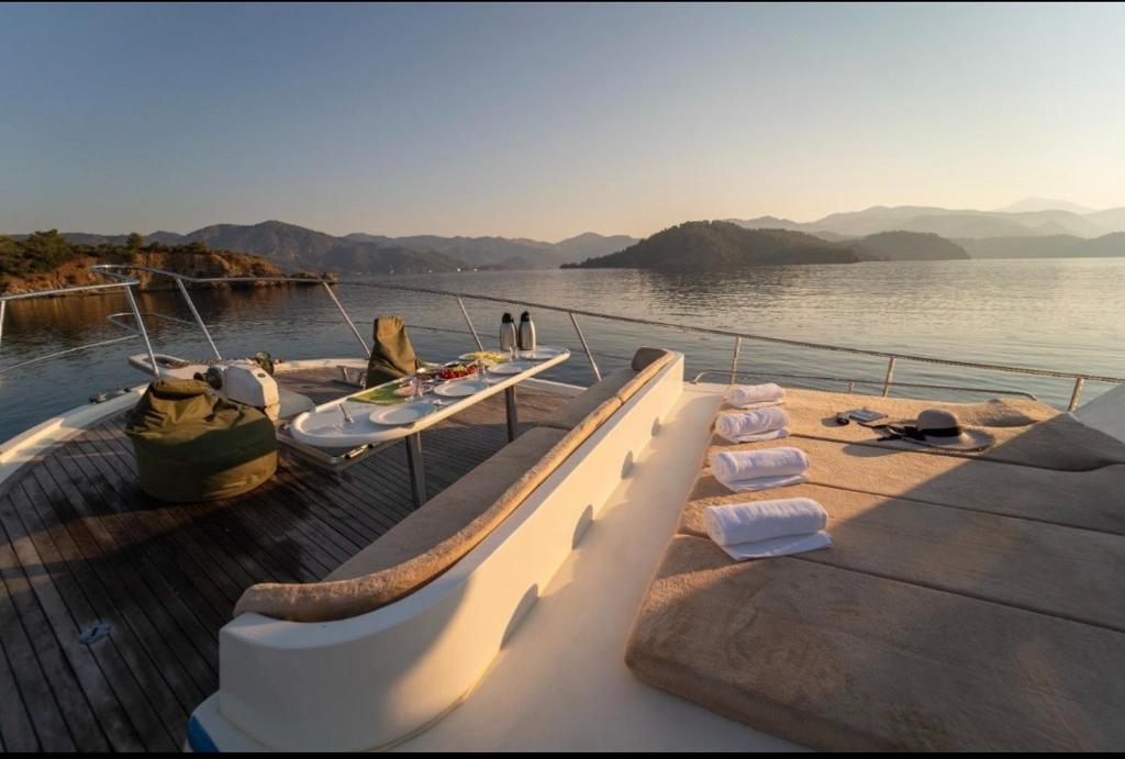 a boat on the water with two beds on it at Aden yachting in Göcek
