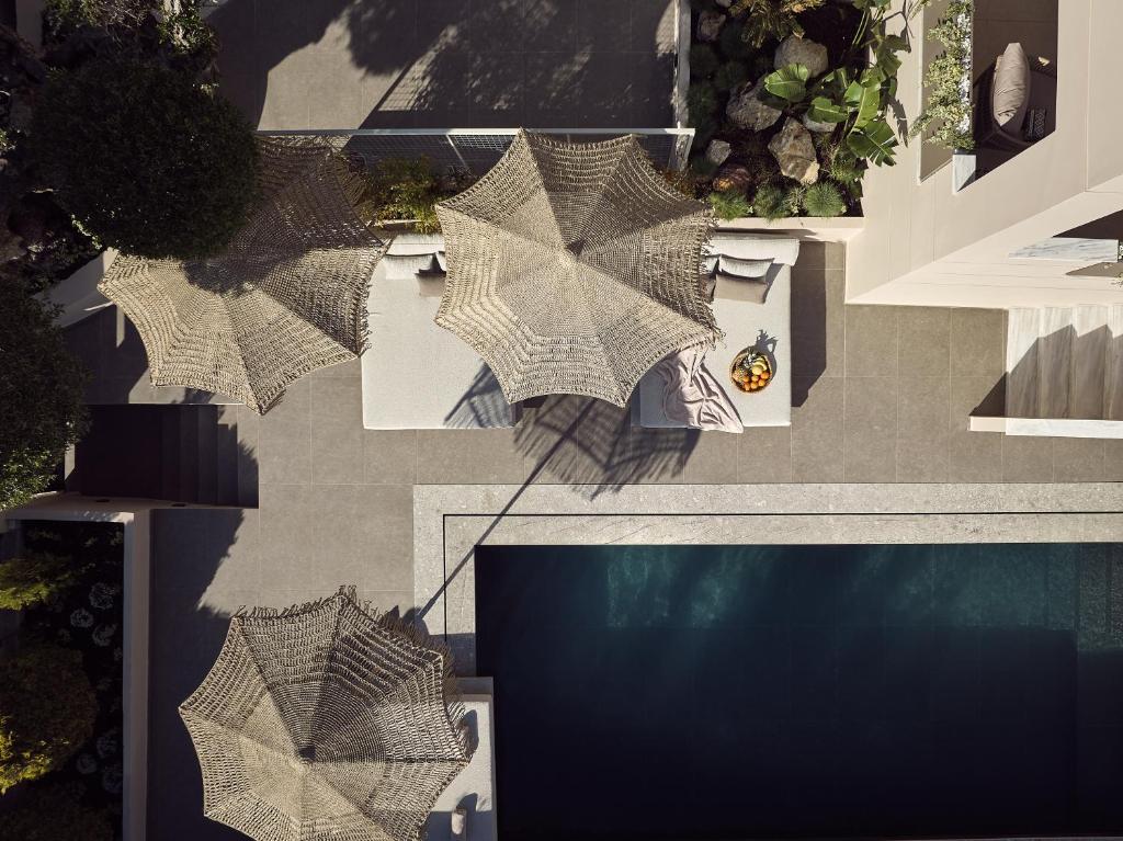 a group of umbrellas on the side of a building at Conte Gesto Villa, with Heated Pool, By ThinkVilla in Akrotiri