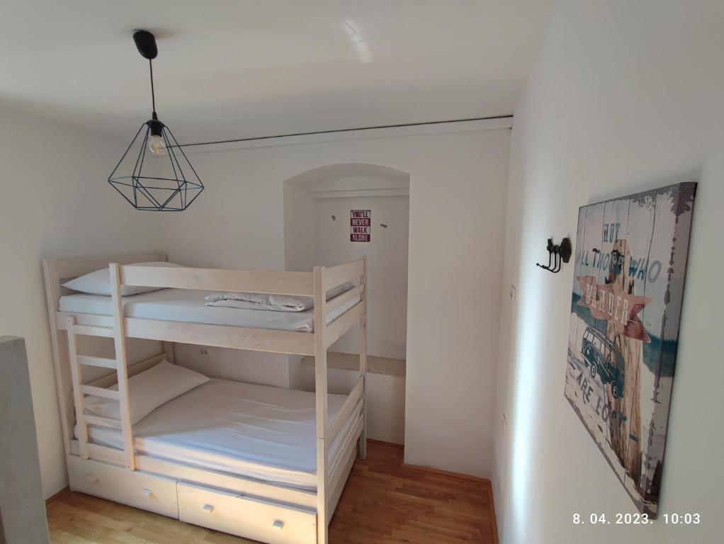 a small room with a bunk bed in it at Impact House Split in Split