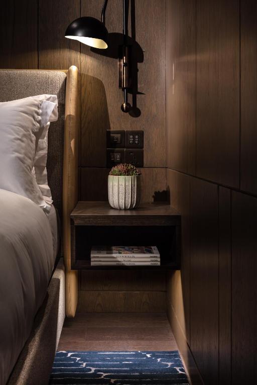 A bed or beds in a room at The Hari Hong Kong