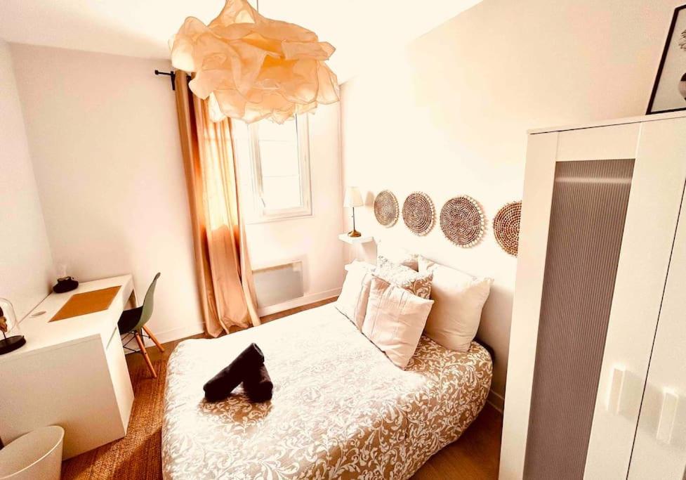 Un dormitorio con una cama con zapatos. en EL DREAM - WiFi NetFlix Centre-ville, en Lisieux