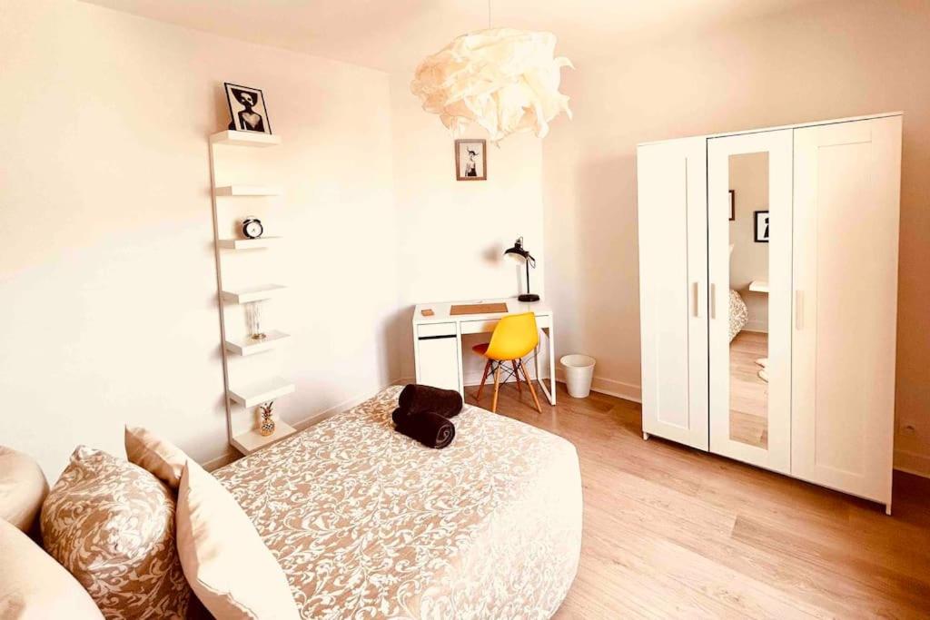 a bedroom with a bed and a desk with a mirror at EL DREAM - WiFi NetFlix Centre-ville in Lisieux