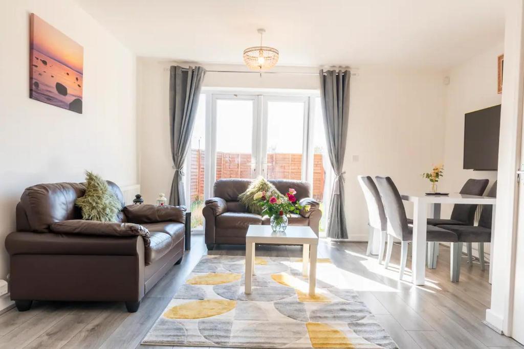 a living room with a couch and a table at Entire House with 3 Rooms in Liverpool