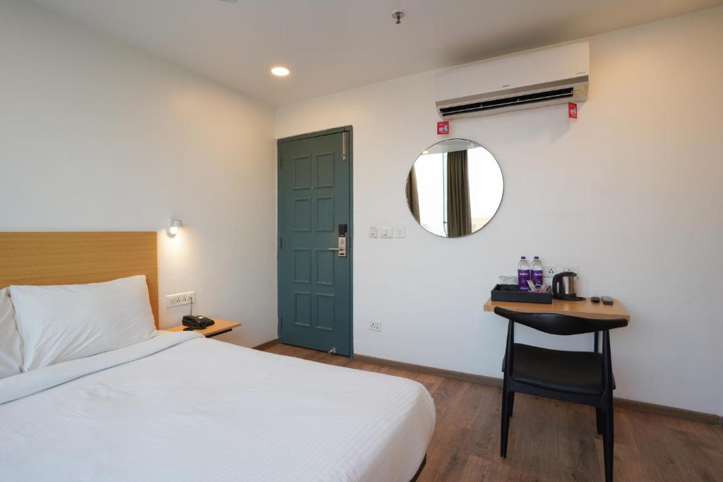 Postel nebo postele na pokoji v ubytování Uptown Hotel