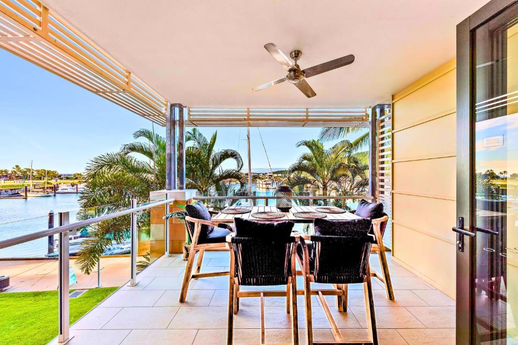 a dining room with a view of the water at Absolute Luxury Marina Lifestyle at The Port of Airlie Beach in Airlie Beach