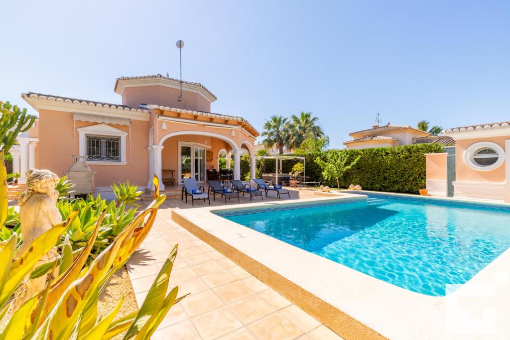 a villa with a swimming pool and a house at Villa Coral - Grupo Turis in Calpe
