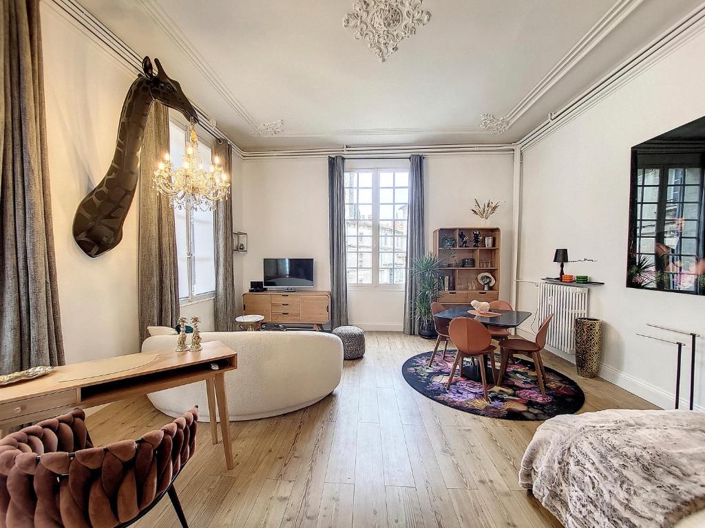 a large living room with a large bed and a table at L'Antre des Papes in Avignon