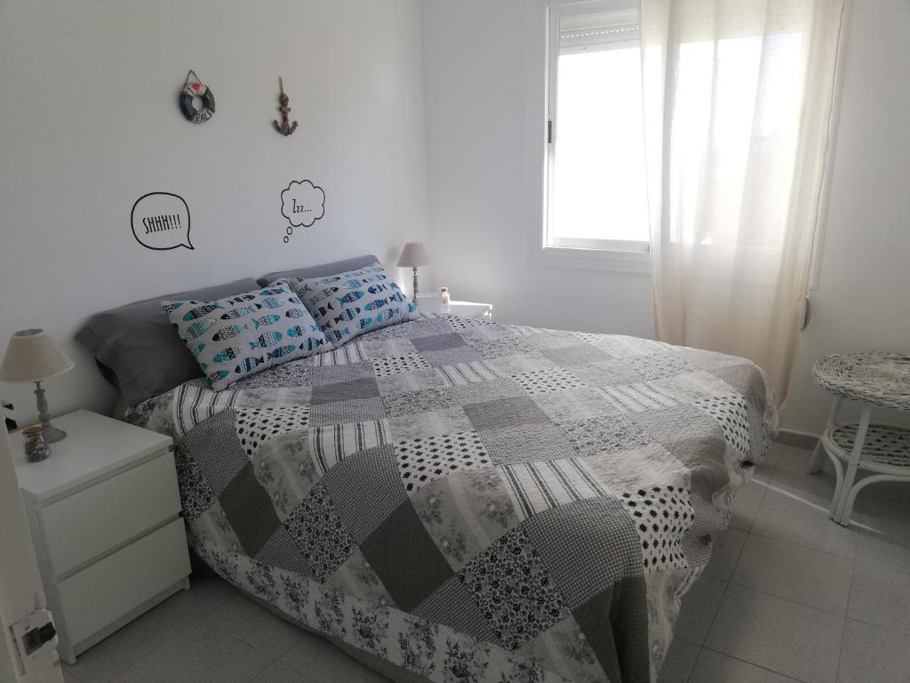 a white bedroom with a bed and a window at Bosmar-5A in Pals