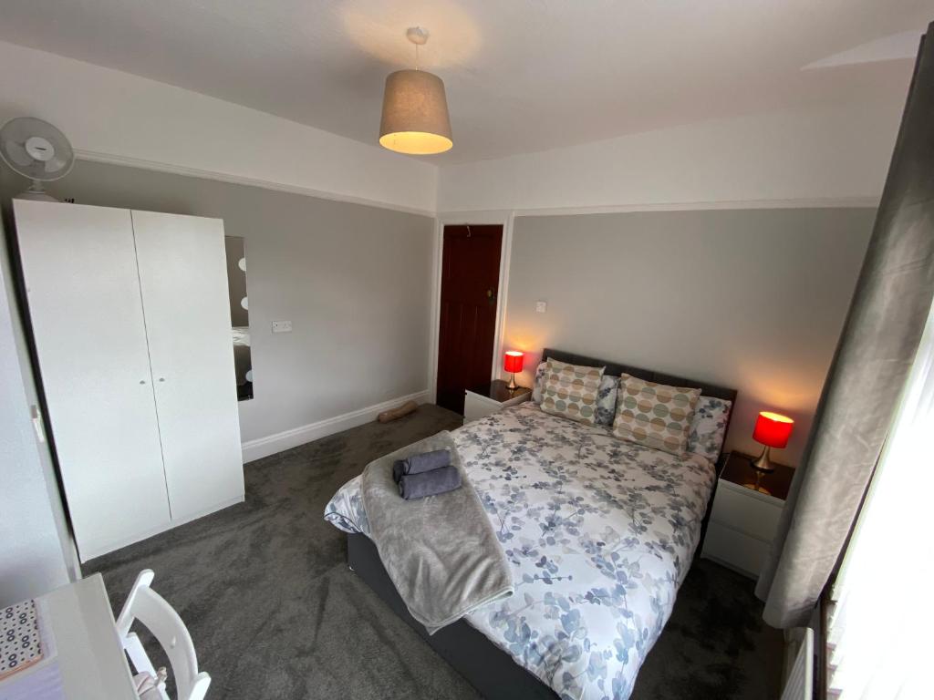 a small bedroom with a bed and a white cabinet at Crumlin Road Town House in Belfast
