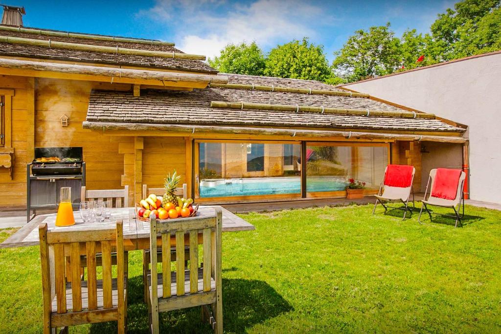 a table with fruit on it in a yard at Chalet Flocon Magique - OVO Network in Saint-Jean-de-Sixt