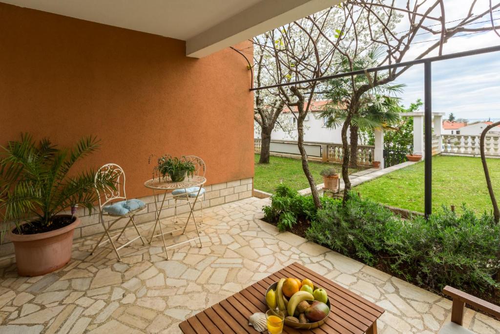 a patio with a bunch of fruit on a table at Apartments Zomzi in Poreč