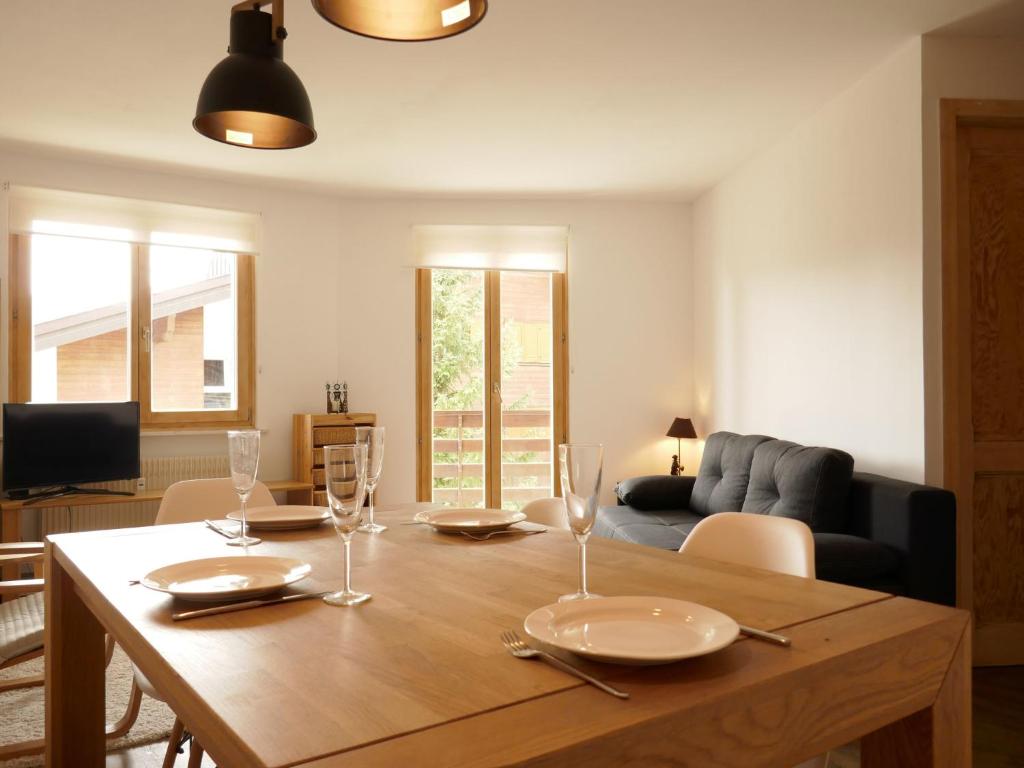 a living room with a wooden table with glasses on it at Apartment Galaxie 110 by Interhome in Verbier