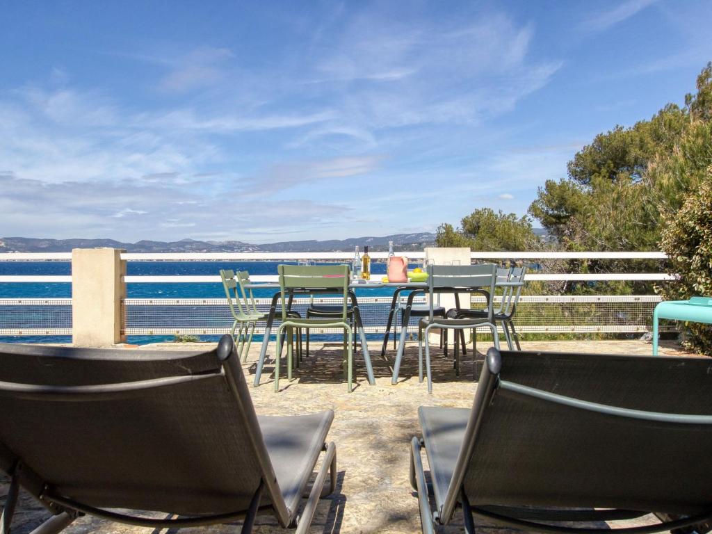 a group of chairs and tables on the beach at Apartment la Rainette by Interhome in La Madrague