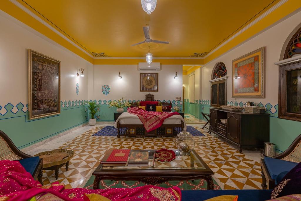 a living room with a couch and a table at Mangalmayee Heritage Home in Jaipur