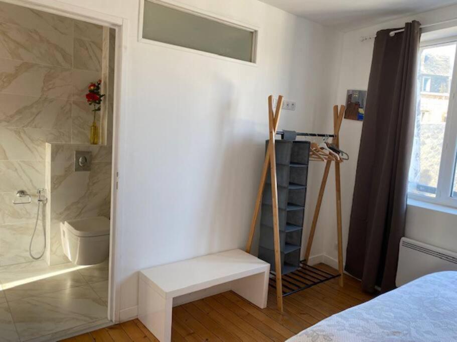 a bathroom with a shower and a bench in a room at Le Domaine : maison proche de la plage et du port in Fécamp