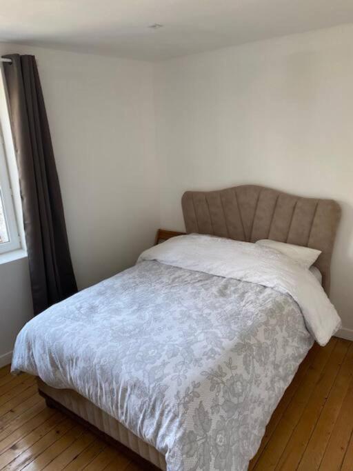 a bedroom with a bed with a blanket and a window at Le Domaine : maison proche de la plage et du port in Fécamp